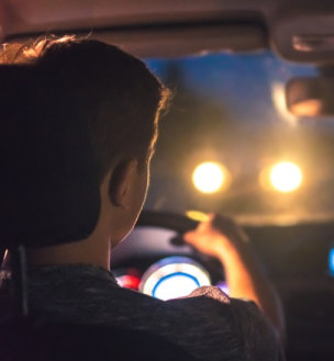 a man driving his car at night